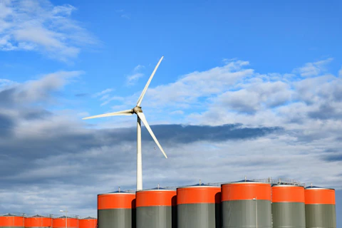 Wind Turbine behind Oil Storage Tanks