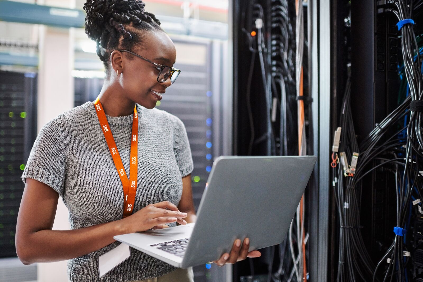 Woman Using a Laptop in a Server Room