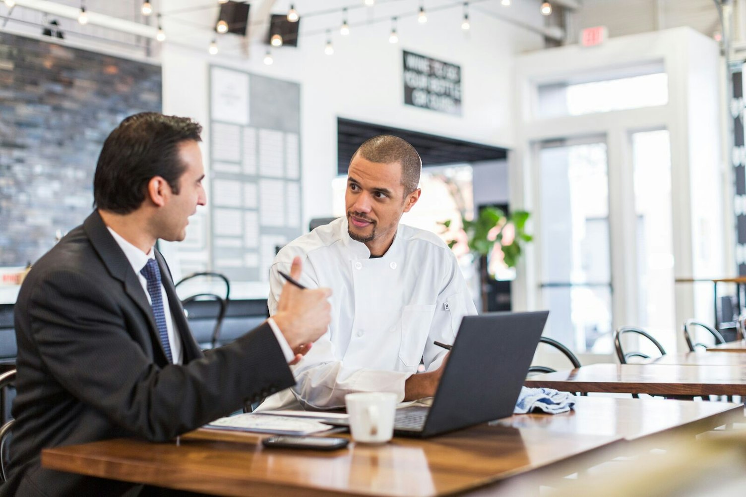 Auditor Meeting with Chef in a Restaurant