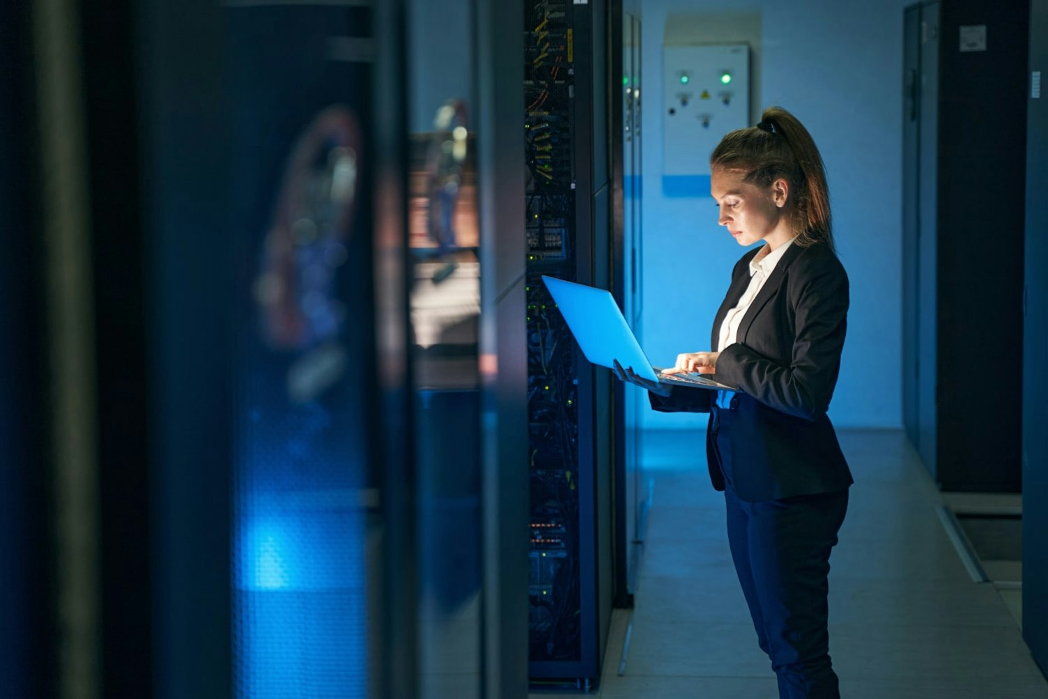 Female Engineer Working in Server Room