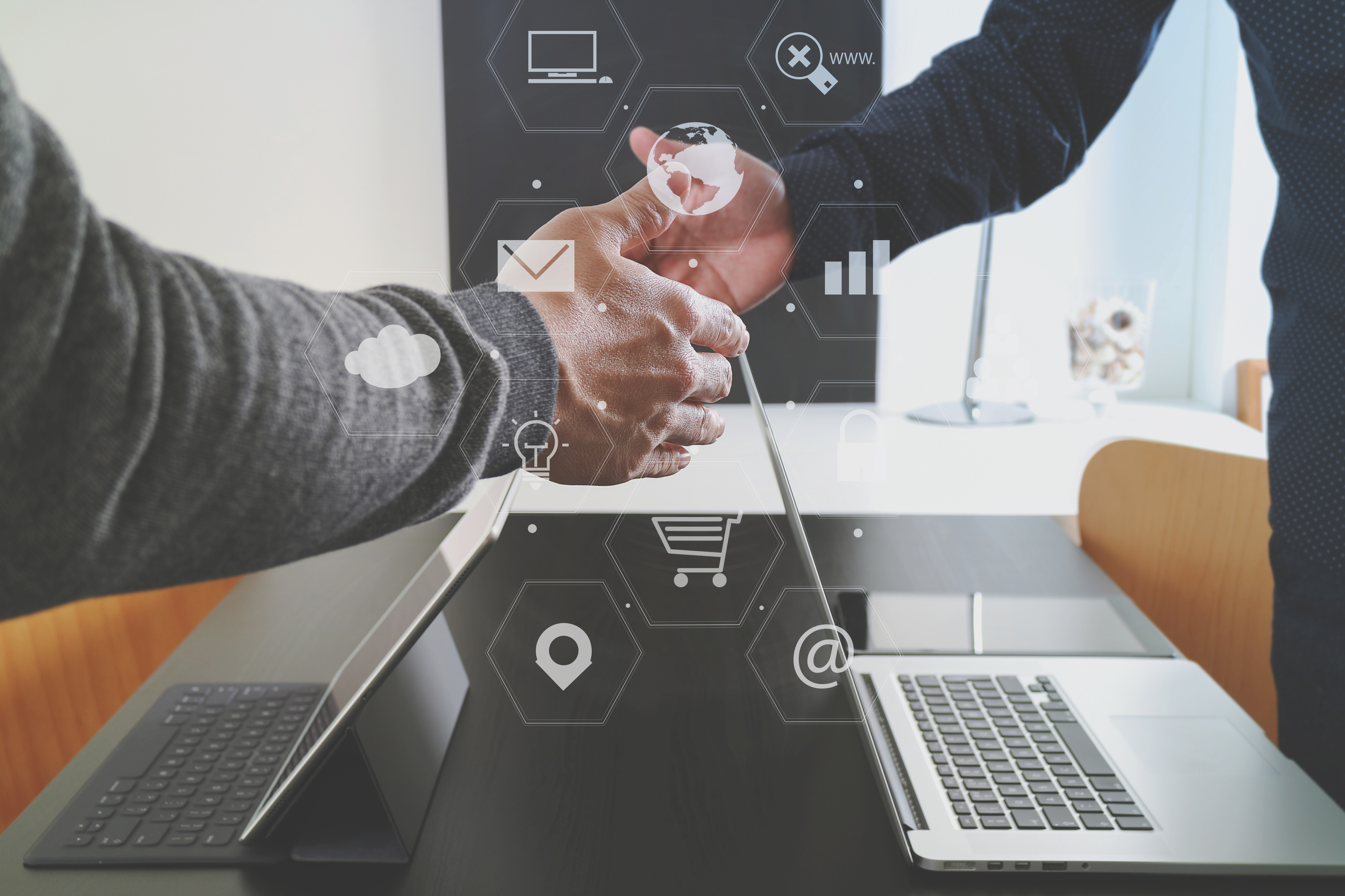 Handshake over Laptop with Digital Design Overlay