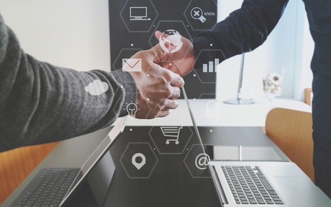 Handshake over Laptop with Digital Design Overlay