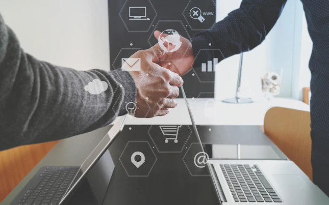Handshake over Laptop with Digital Design Overlay