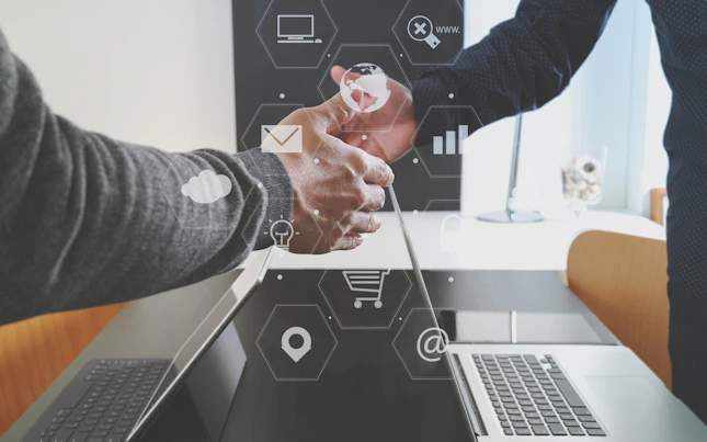 Handshake over Laptop with Digital Design Overlay