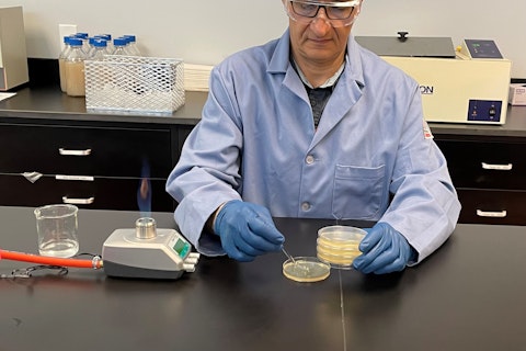 Scientist placing sample in a petri dish