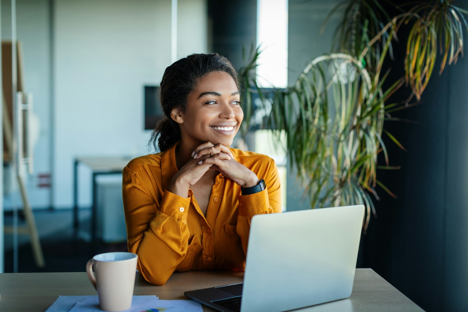 Smiling Businesswoman Sitting at her Desk