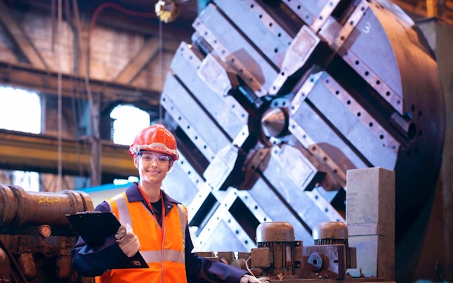 Smiling Worker in Steel Factory
