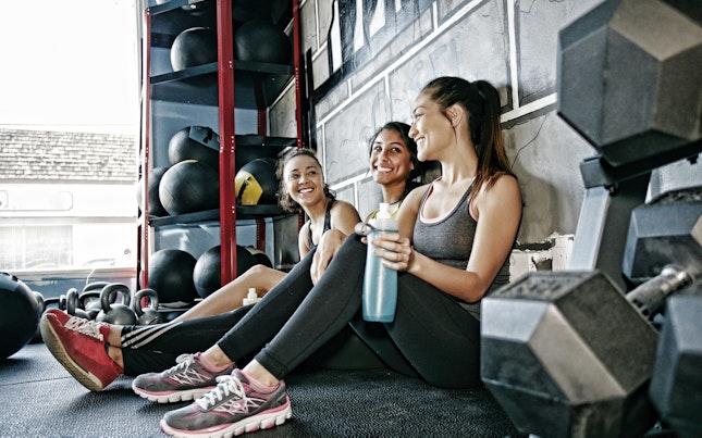 Women Sitting on the Floor Resting at the Gym