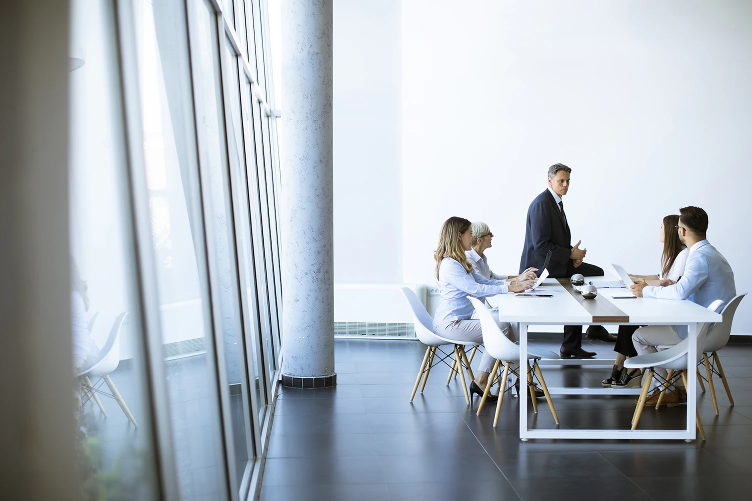 Young Adults Senior Woman Colleague Meeting Modern Bright Office Interior