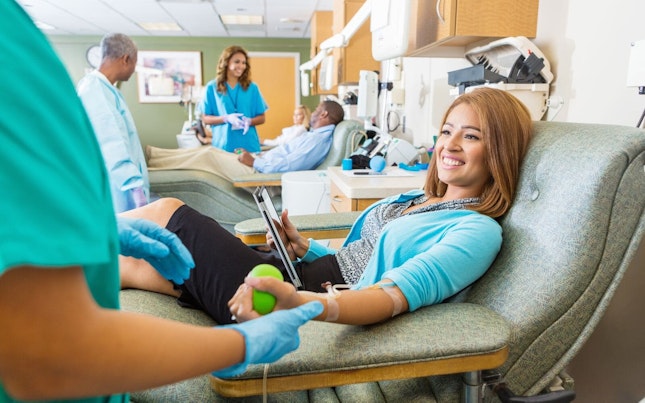 Young Woman Donating Blood in Donation Center