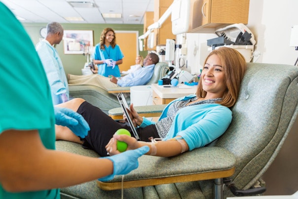 Young Woman Donating Blood in Donation Center