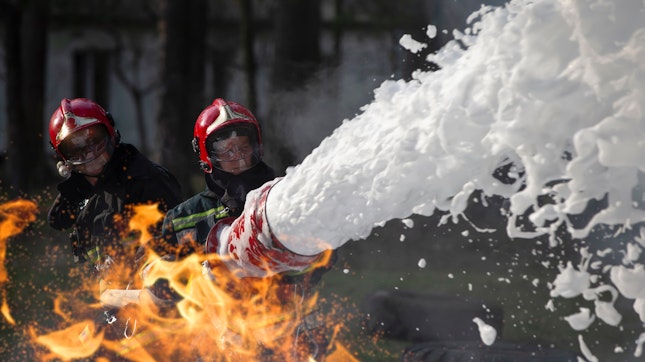 Fire Fighters Extinguishing a Fire with Foam