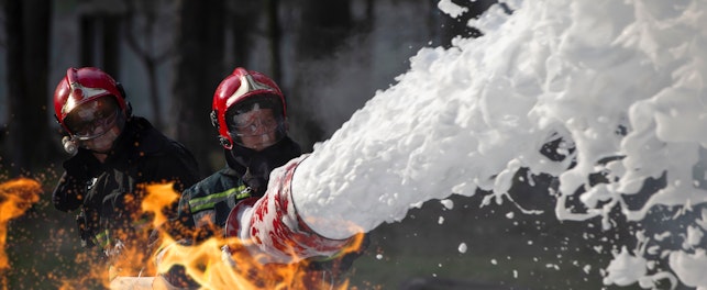 Fire Fighters Extinguishing a Fire with Foam