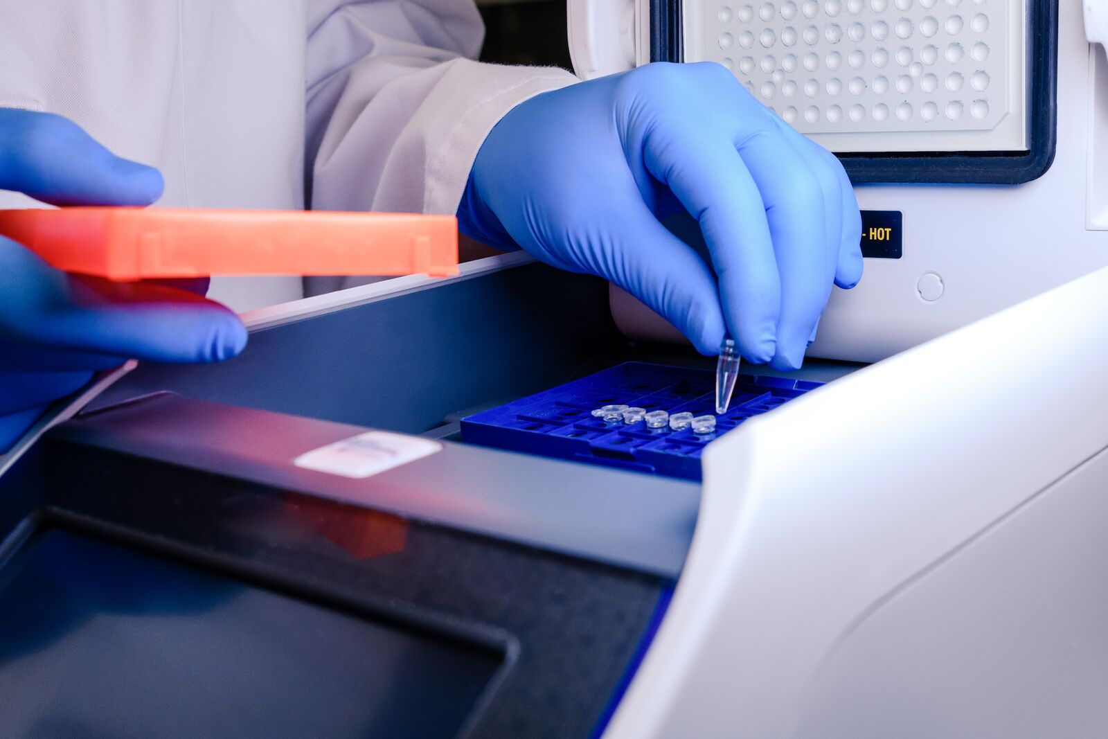 Loading a DNA Tube into a PCR Polymerase Chain Reaction Thermocycler Machine