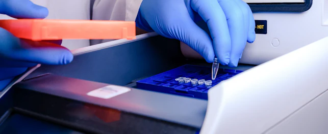 Loading a DNA Tube into a PCR Polymerase Chain Reaction Thermocycler Machine