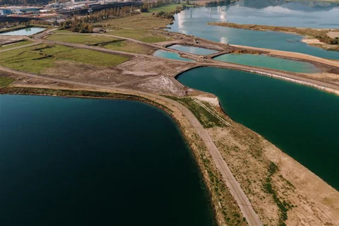 aerial-shot-landscape-surrounded-by-mountains-lakes-with-industrial-disaster 1