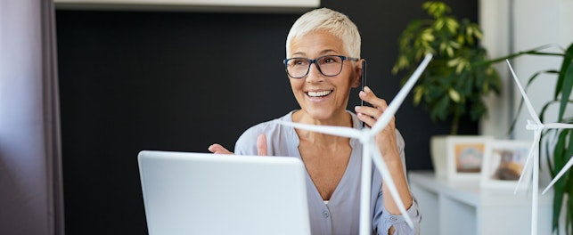 Woman Working at a Desk with Windmill Model