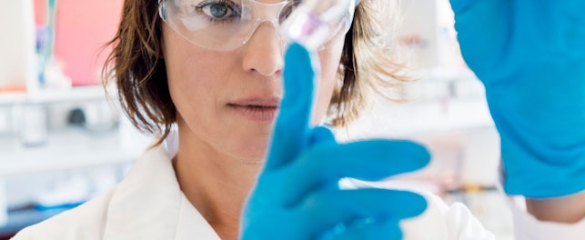 Chemist looking at liquid in test tube