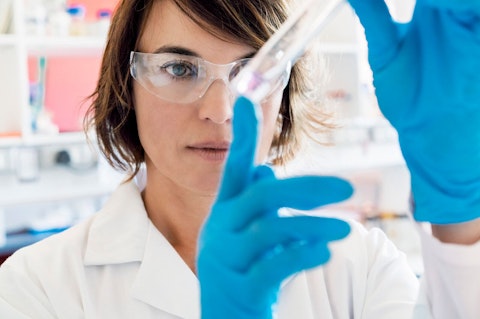 Chemist looking at liquid in test tube