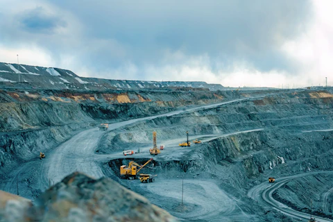Work of trucks and the excavator in an open pit