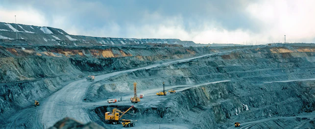 Work of trucks and the excavator in an open pit