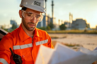 Engineer looking at refinery plans