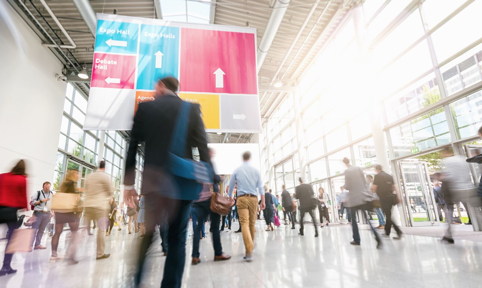 Blurred Silhouettes Walking in a Large Exhibition Hall