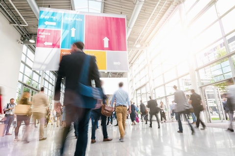 Blurred Silhouettes Walking in a Large Exhibition Hall