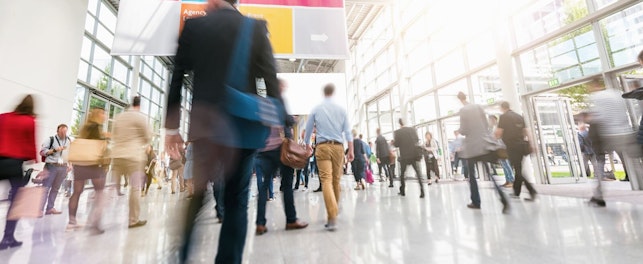 Blurred Silhouettes Walking in a Large Exhibition Hall
