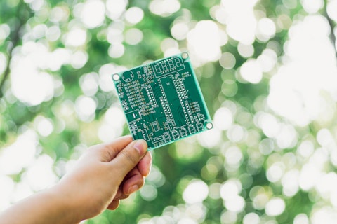 Hand Holding Green Circuit Board