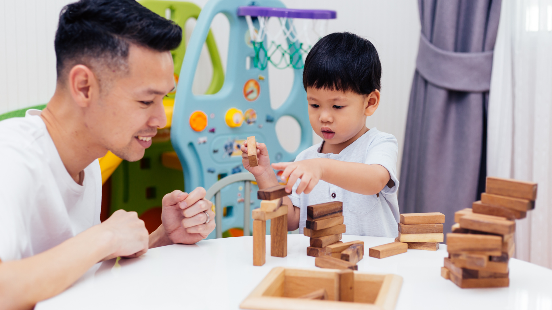Asian Child and Father Playing with Wooden Blocks