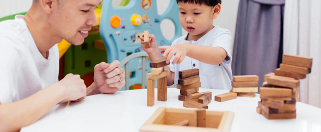 Asian Child and Father Playing with Wooden Blocks