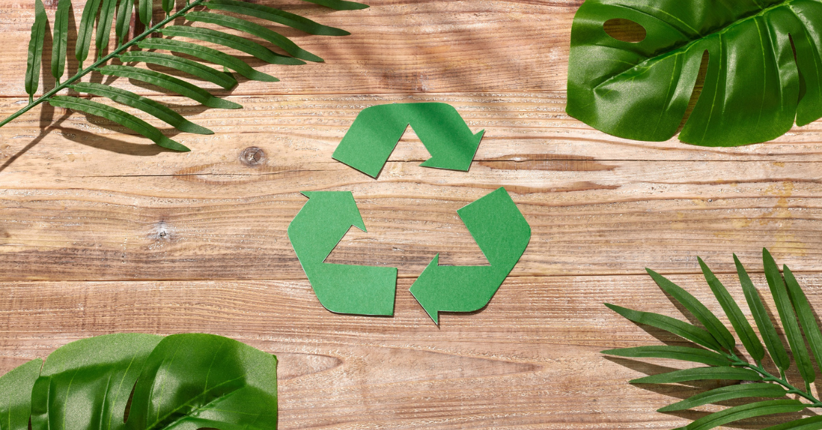Recycling Symbol Surrounded by Tropical Leaves