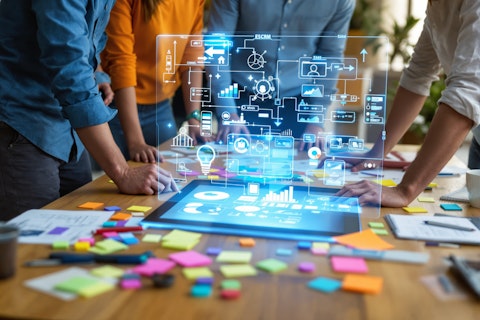 team collaborating on a digital project using a tablet with holographic interface