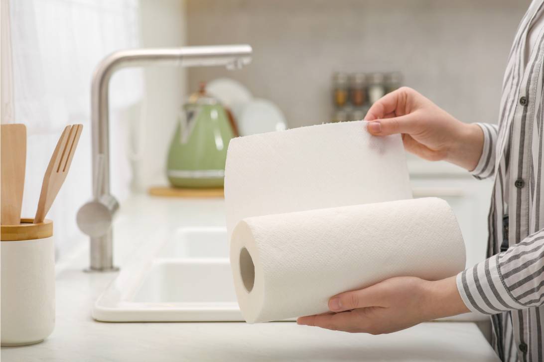 Woman Tearing Paper Towels in Kitchen Closeup 1092px