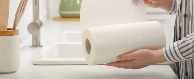 Woman Tearing Paper Towels in Kitchen Closeup 1092px