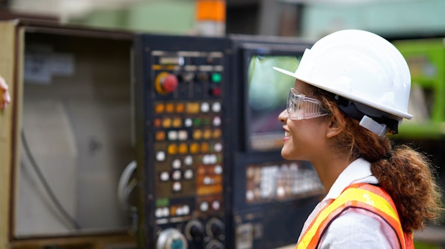Factory Engineer Examining Production Line Machinery