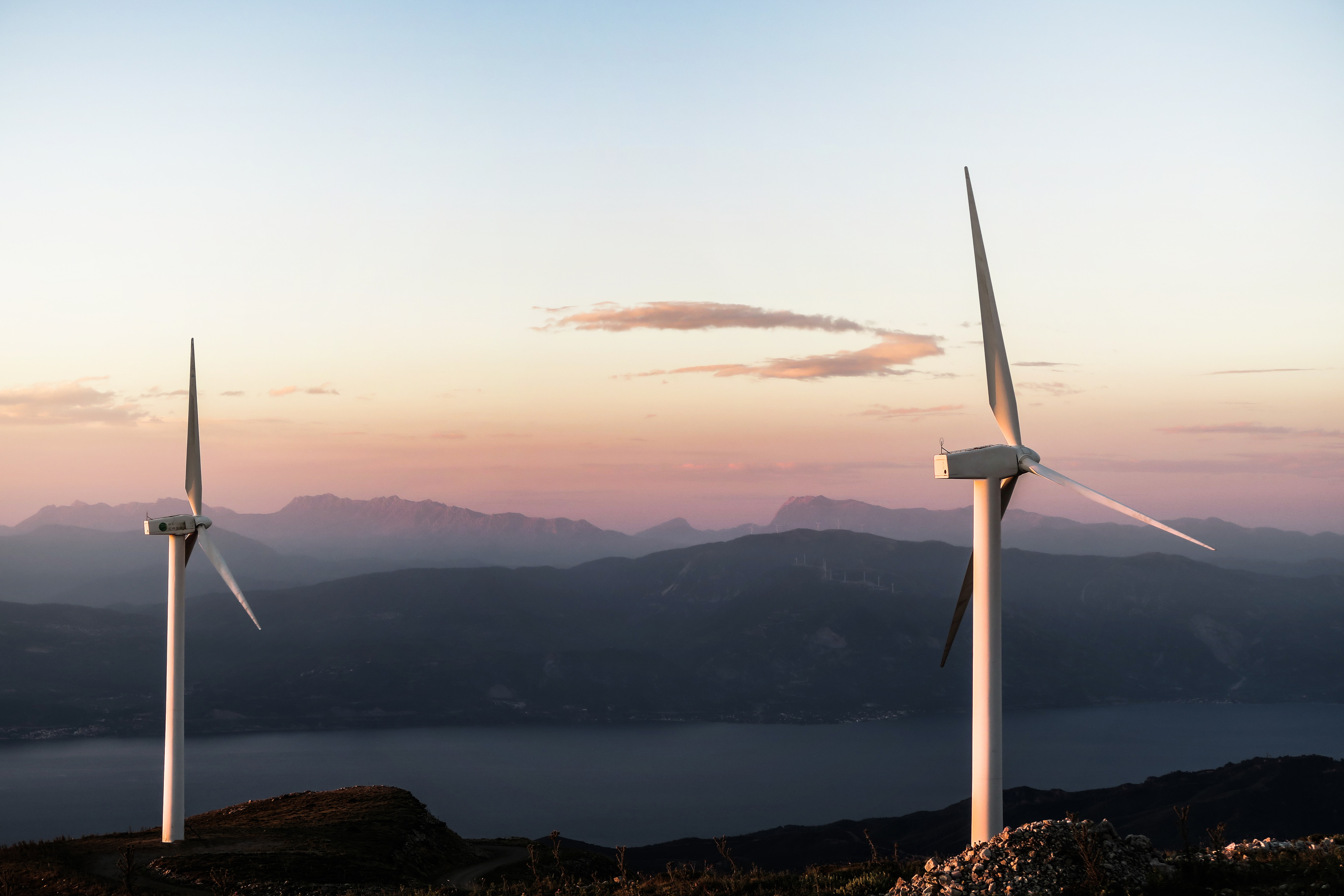 Orig wind turbines on a hill-unsplash