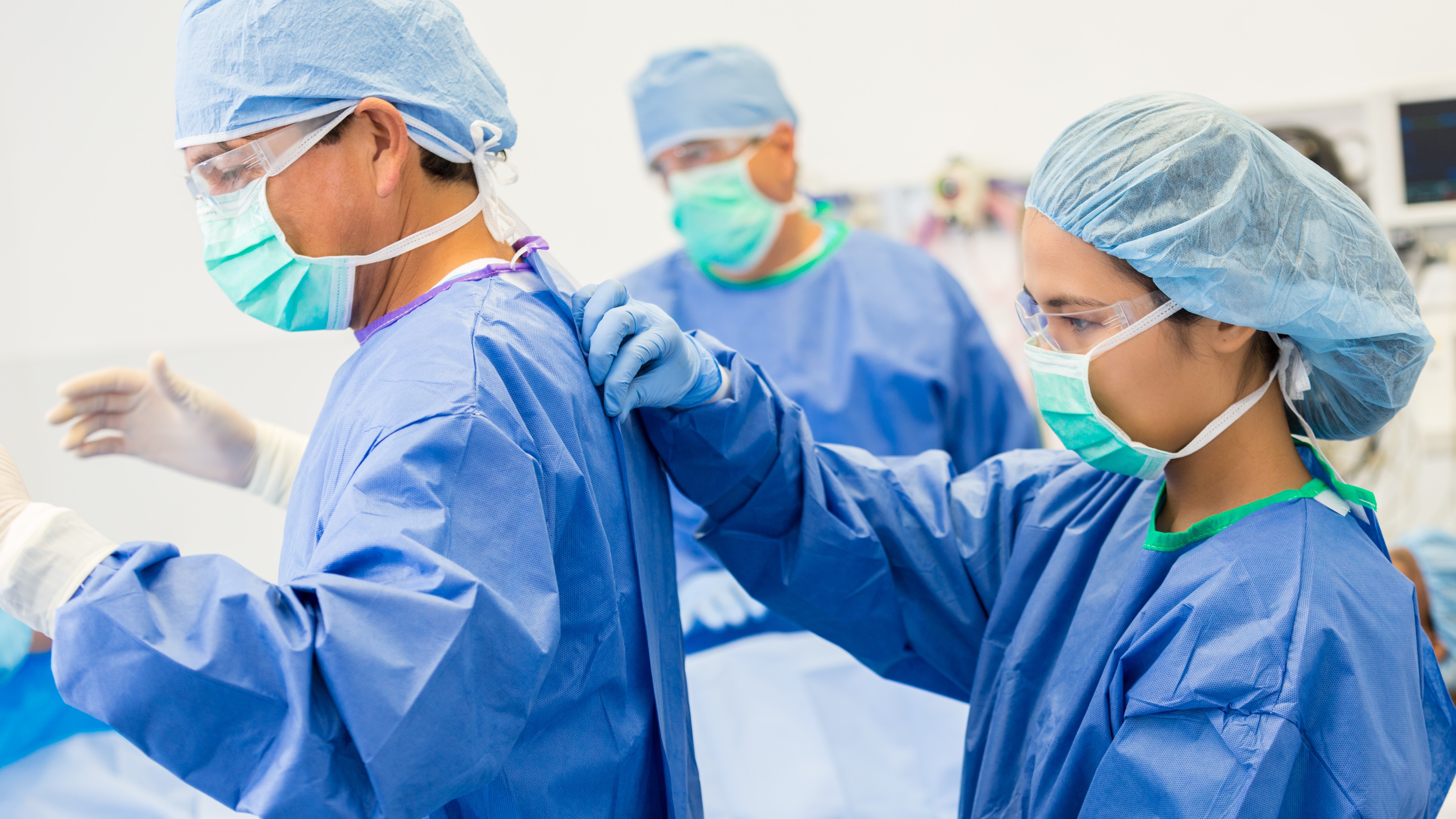 Surgeons Putting on Sterile Gown