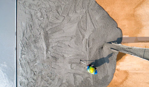Construction Workers Pouring Wet Concrete