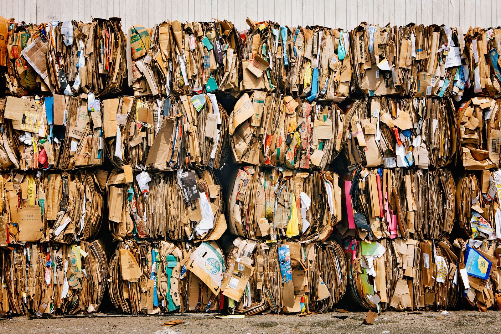 Stosy zużytych kartonowych opakowań przygotowanych do recyklingu.
