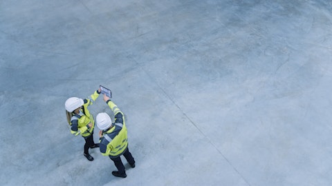 Construction Engineers Inspecting a Site Using a Software on a Digital Tablet