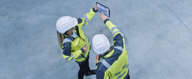 Construction Engineers Inspecting a Site Using a Software on a Digital Tablet