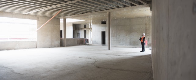Auditor Inspecting Building under Construction
