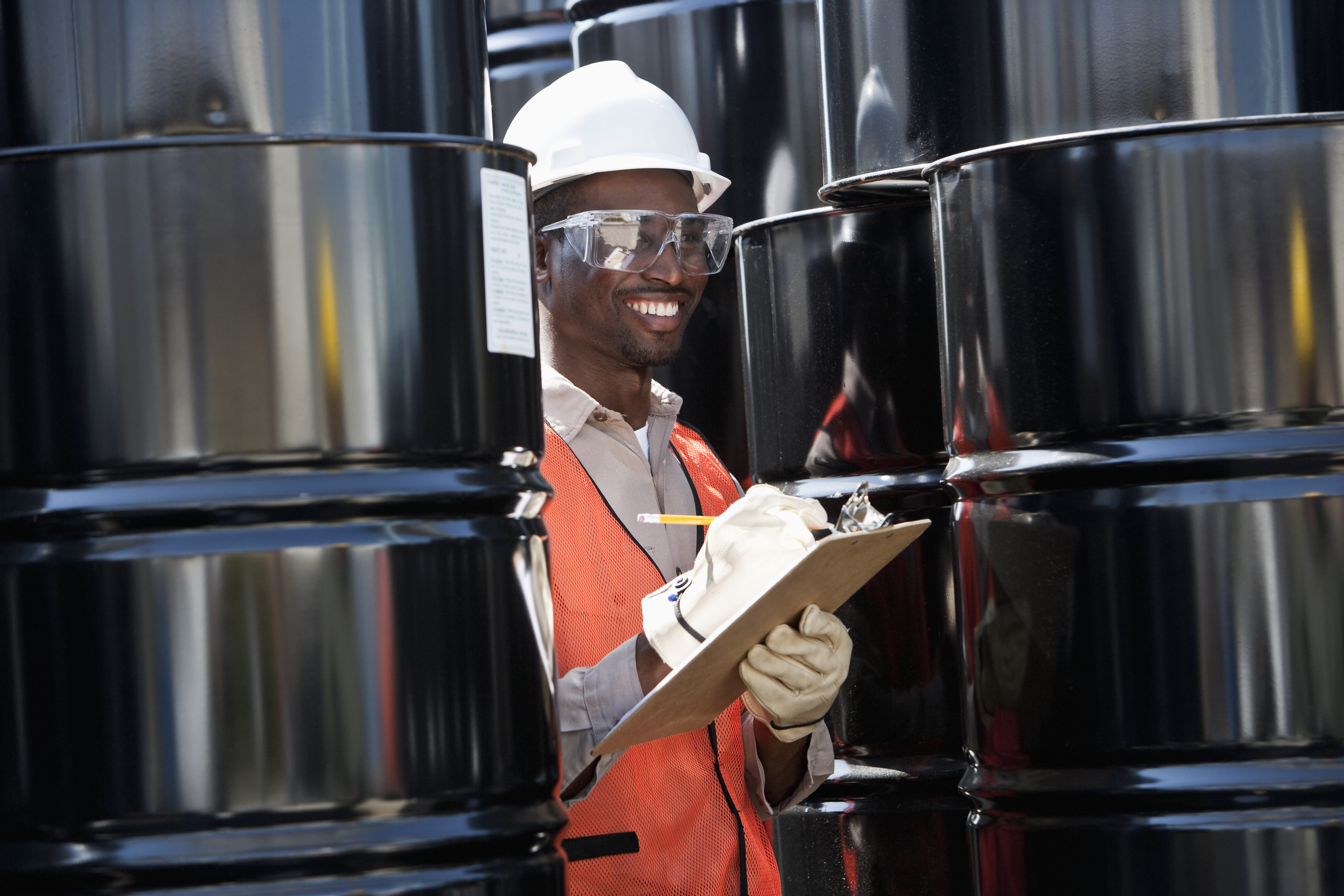 Auditor Taking Inventory of Steel Drums