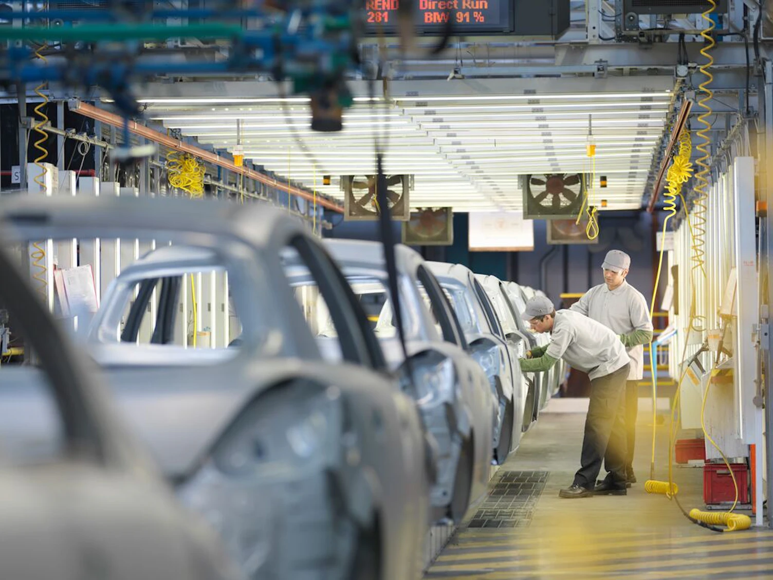 car plant workers on production line