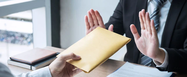Anti bribery and corruption concept, Business man refusing and don't receive money banknote in envelope offer from business people to accept agreement contract of investment deal.