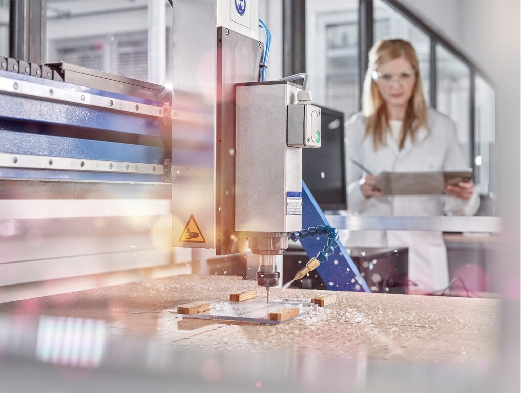 Technician Controlling CNC Milling Machine