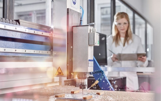 Technician Controlling CNC Milling Machine
