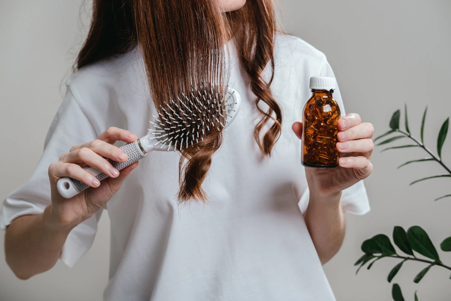 A woman holds omega 3 fish oil capsules
